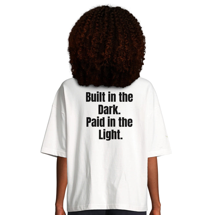 Women's Oversized T-shirt with "Built in the Dark Paid in the Light" slogan – 