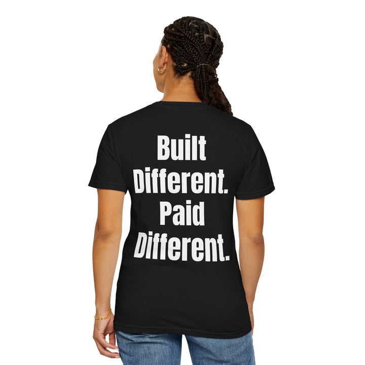 Unisex "Built Different, Paid Different" motivational t-shirt in garment-dyed fabric, offering relaxed fit and unique texture for a stylish, comfortable everyday look.