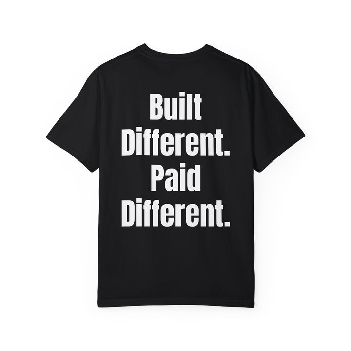 Unisex "Built Different, Paid Different" motivational t-shirt in garment-dyed fabric, offering relaxed fit and unique texture for a stylish, comfortable everyday look.